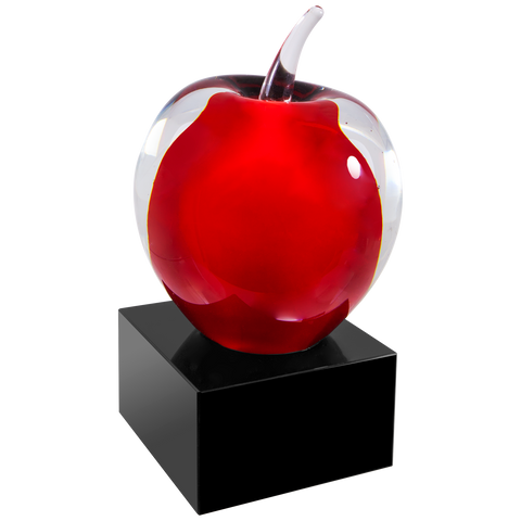 clear and red glass apple on a black glass base